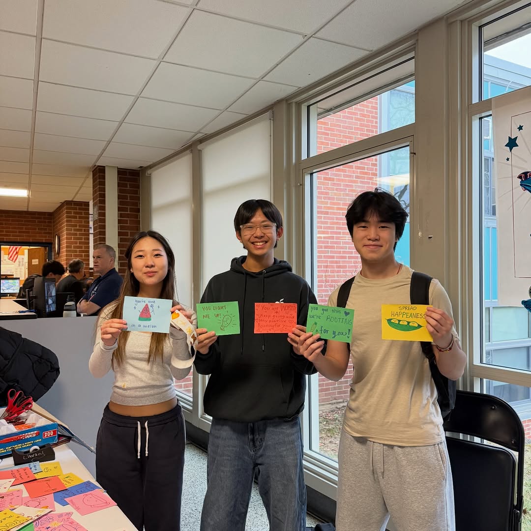 Students holding handmade cards at the Dec 2 event